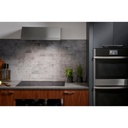 GE-PHP9030DTBB-Modern kitchen with an induction cooktop and range hood
